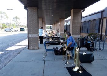 Schmidt’s Music employees (from closest to farthest) Michael Glenn, Joe Hooten, and Jeanie Harnish at an outdoor horn drive.