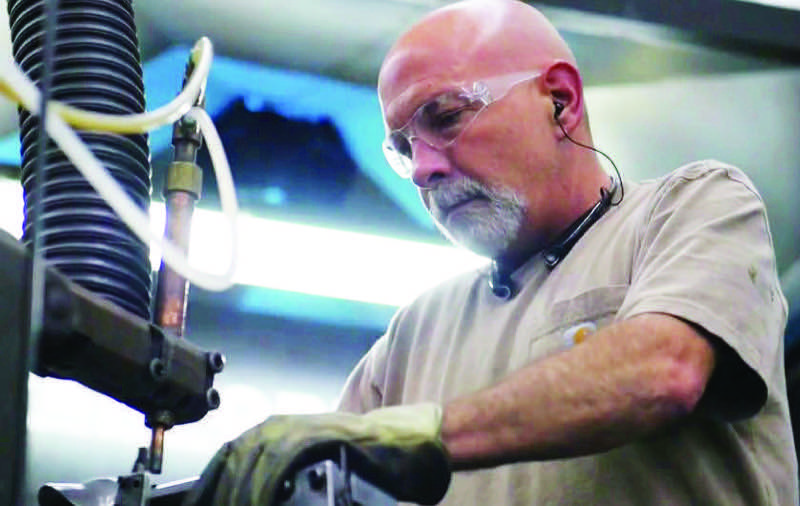 Mike Lizotte, an employee and current board member, at work in the assembly plant