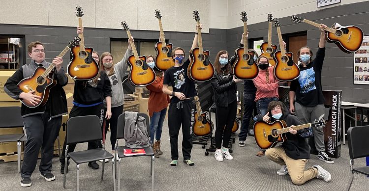 Students from Upperman High School in Baxter, TN, holding their new guitars, the result of a grant from the Guitar Center Music Foundation, who drew from Guitar Center’s in-store and online fundraising initiatives known as the “Round Up Your Change” program