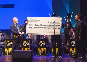 Jody Espina presents a check to Caleb Chapman for JodyJazz’s $10,000 donation to the Sound Support Foundation at their recent Scholarship concert in Salt Lake City
