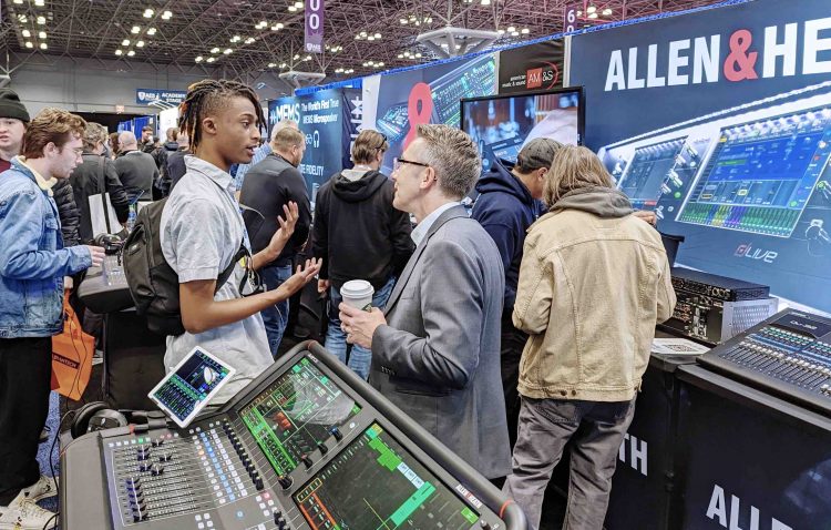 Allen & Heath USA National Sales Manager Pat McConnell speaks with a boot guest at the AES2022 Show