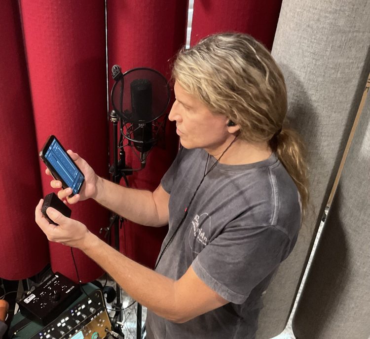 Mitch Malloy, shown in the studio using his ASI Audio x Sensaphonics 3DME Gen2 Active Ambient Monitoring System and the free ASI Audio App