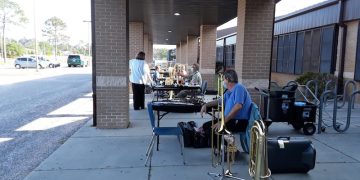 Schmidt’s Music employees (from closest to farthest) Michael Glenn, Joe Hooten, and Jeanie Harnish at an outdoor horn drive.